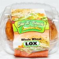 Whole Wheat Lox · On mezonos roll with cherry tomato and pickle.
