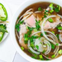 House Combo Phở (Đặc Biệt) · Combination of rare beef and brisket served with bean sprouts, basil, and lime.
