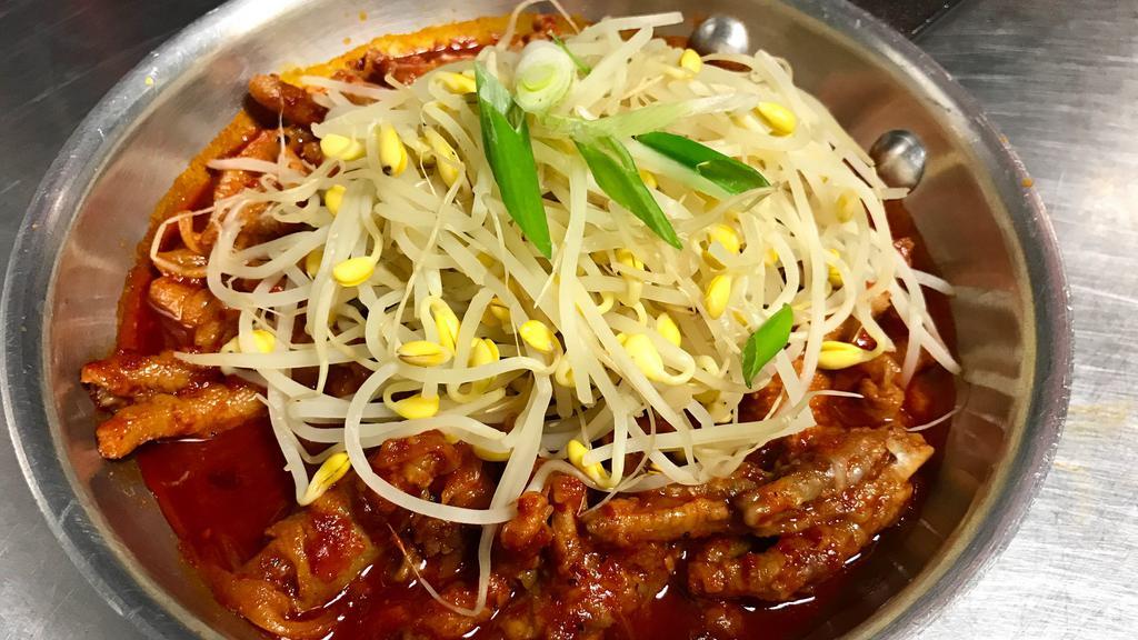 Bean Sprout Chicken Feet · Chicken feet in spicy soup with bean sprout and clear noodles on top.