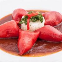 Pimientos Con Bacalao · Red piquillo peppers stuffed with codfish on salsa vizcaina