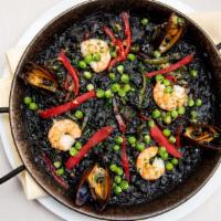 Arroz Negro · Black rice with squid paella style served with aoili