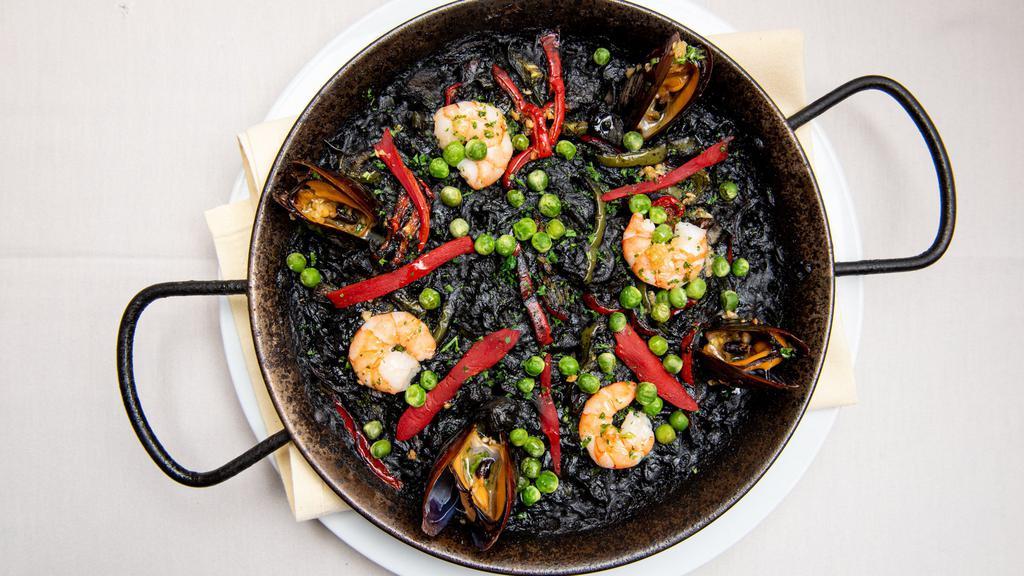 Arroz Negro · Black rice with squid paella style served with aoili