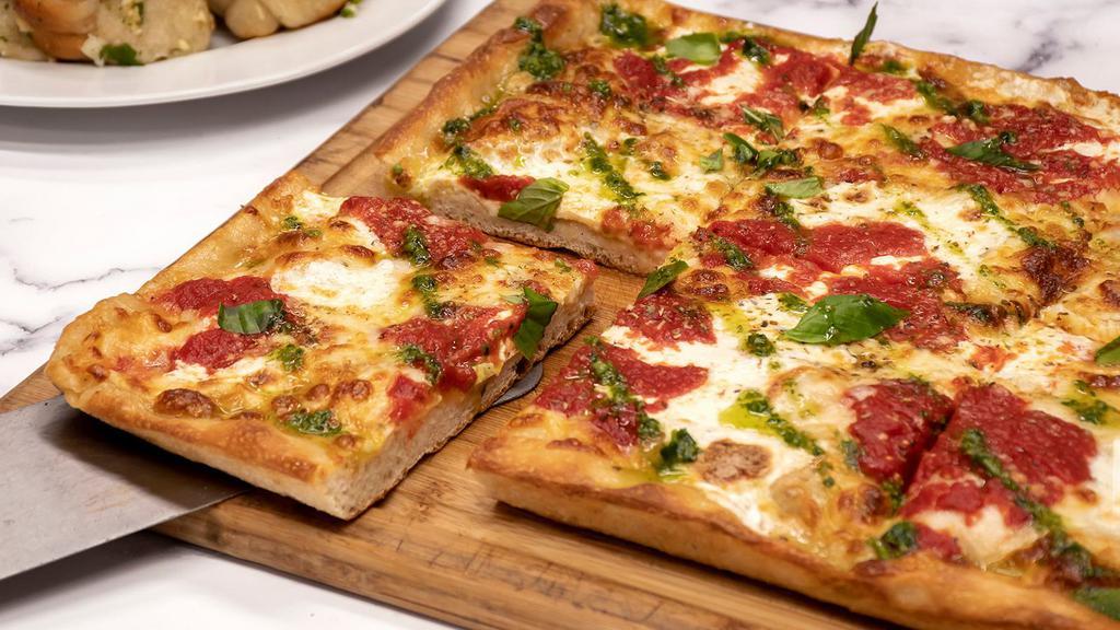 Genovese Grandma Style Pizza · 12'' x 17'' Pie (8 Slices) Tomato sauce, fresh mozzarella, shredded mozzarella and pesto.
