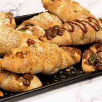 Pizza Rolls · Flavored chicken and mozzarella cheese wrapped in pizza dough and baked to perfection.