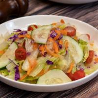 Garden Salad · Chopped romaine, cucumbers, tomatoes, onions with our homemade Italian dressing.