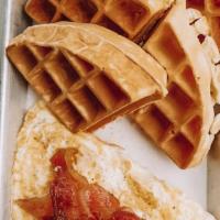 Aussie Waffle · House made waffle topped with bacon and 2 fried cage free eggs. Comes with a side of Organic...