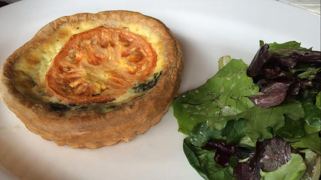 Quiche Of The Day · With mixed greens.
