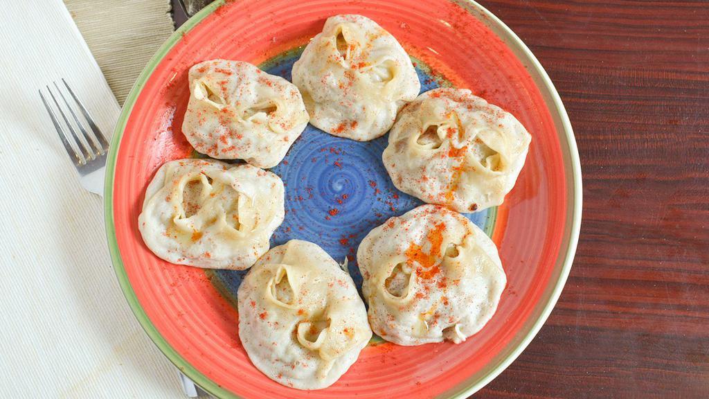 Manti · Steamed dumplings with chopped onions and meat.