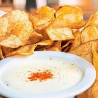Old Bay Kettle Chips W/ Queso · Crispy kettle chips seasoned with Old Bay served with creamy queso with a hint of jalapenos ...