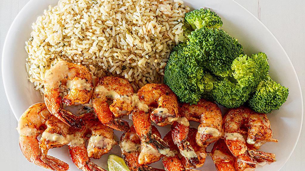 Island Grilled Shrimp · Grilled shrimp skewers are perfectly seasoned in a smoky mesquite rub, drizzled in garlic parm sauce. Served with two sides. (540-1080 cal.)