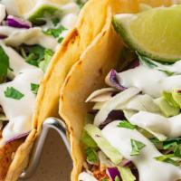 Baja Fish Taco · Grilled mahi mahi is rubbed with cajun seasoning, topped with shredded cabbage, lime crema a...