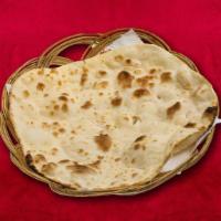 Naan · Fluffy dough properly smashed and baked in an Indian tandoor oven.