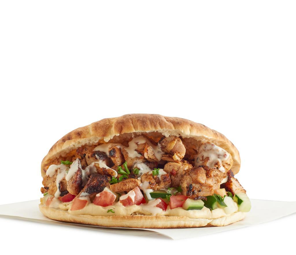 Spicy Grilled Chicken Sandwich · Grilled marinated chicken thighs with our signature spices. Pita with a spread of hummus and salad (tomatoes, cucumber, mint, parsley and lemon dressing) topped with tahini.