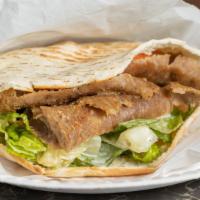 Lamb Shawarma · Layers of marinated lamb with special spices rotated in a vertical grill pit. On a toasted p...