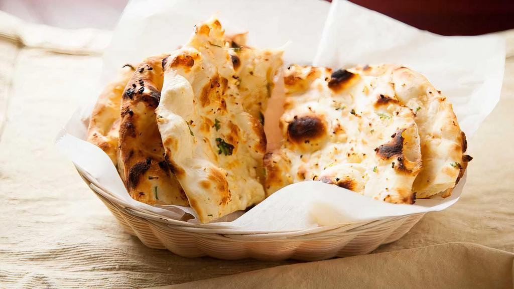 Garlic Naan · Leavened white flour and garlic bread baked from clay oven.