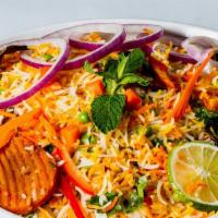 Vegetable Biryani · Spicy, gluten free. Basmati rice cooked with vegetables, herbs, spices and garnished with on...