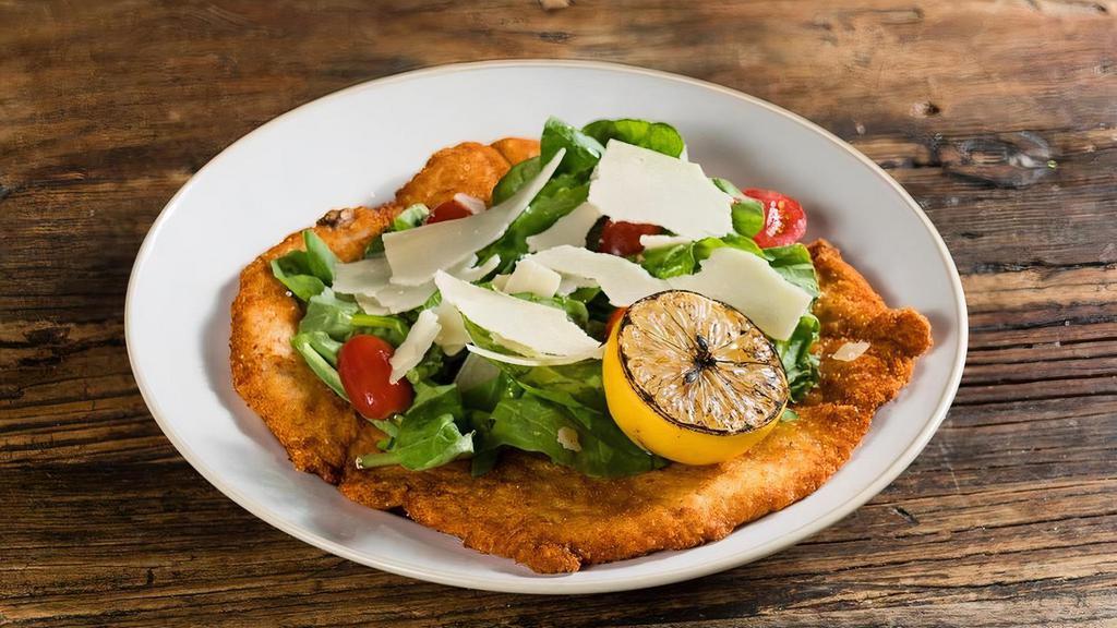 Milanese · traditional chicken Milanese, wild arugula, cherry tomatoes, shaved Parmigiano, balsamic reduction