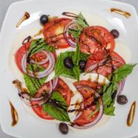 Caprese Salad · Fresh mozzarella, ripe tomatoes, fresh basil sliced red onion, olives, frankies E.V.O.O.