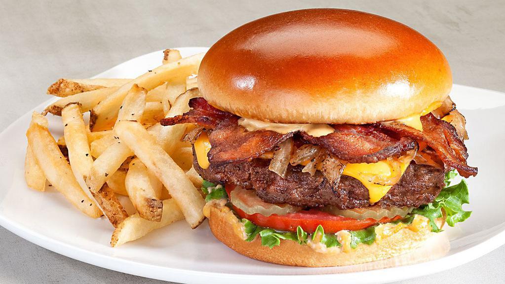 Smoky Chipotle Burger · Bacon, American cheese, caramelized onions, spicy chipotle mayo, brioche bun, lettuce, tomato, pickles. 1360 calories.