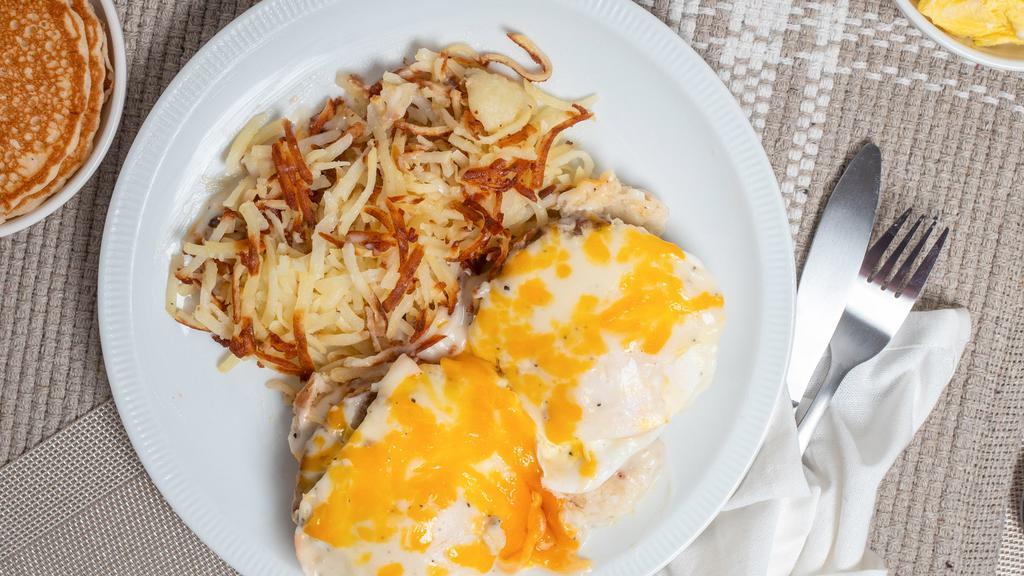 Country Benedict · Sliced buttermilk biscuit sausage patties over-medium eggs country sausage gravy and cheddar cheese.