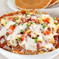 Carnitas Queso Skillet · Seasoned hash browns pulled pork bacon sausage tomatoes onions; white queso jack cheese gree...