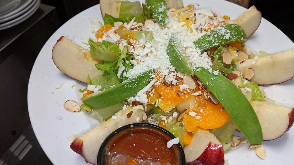 Apple Salad · Fresh romaine and iceberg mix, red and green apples, dried cranberries, queso fresco and sliced almonds. Served with our special mango chipotle dressing.