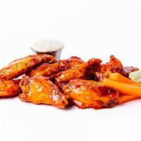 *12 Chicken Wings* · Crispy chicken wings tossed in our signature Tap Room hot sauce and served with celery, carr...