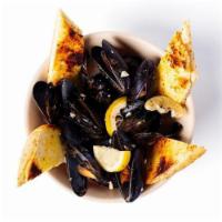 *White Mussels* · Our famous mussels prepared in a white wine sauce. Served with garlic bread.