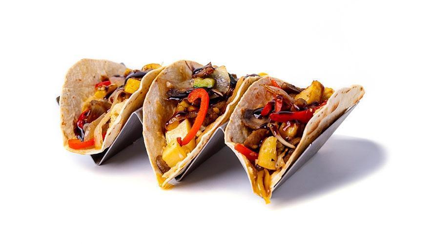 Roasted Hummus Tacos · Roasted hummus topped with sauteed zucchini, squash, mushrooms, red and yellow peppers, drizzled with balsamic glaze.