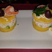 Causa De Camarones · Peruvian style mashed potatoes filled with shrimp salad.