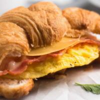 Croissant With Bacon, Egg, And Cheese · Buttery and flaky croissant filled with fresh eggs, crispy bacon, and melted cheese.