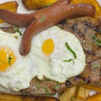 Bistec A Lo Pobre · Grilled steak served with fried sweet plantain, French fries, slices of sausage, and two fri...