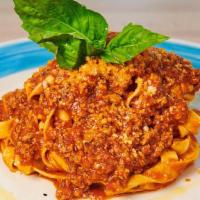 Fettuccine Bolognese · Fettuccine (egg pasta) with beef meat sauce ragu and Parmigiano reggiano