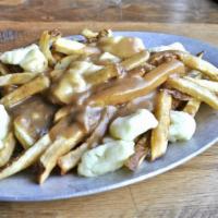 Classic Poutine · Crispy house cut fries topped with cheese curds and brown gravy.