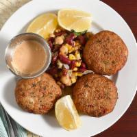 Maryland Lump Crab Cakes · Two crab cakes made with lump crab meat, served on a bed of greens with a kicking bayou dipp...
