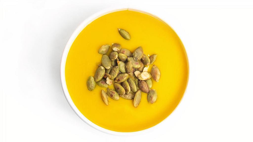 Creamy Butternut Squash & Ginger Soup · Chef crafted ginger forward cream of butternut squash soup, finished with crunchy pumpkin seeds. (VG)