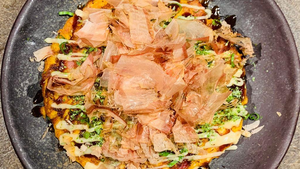 Kimchi Okonomiyaki · Okonomi Sauce, Mayonnaise, Kimchi, Cabbage, Bacon, Egg, Flour, and Scallion.