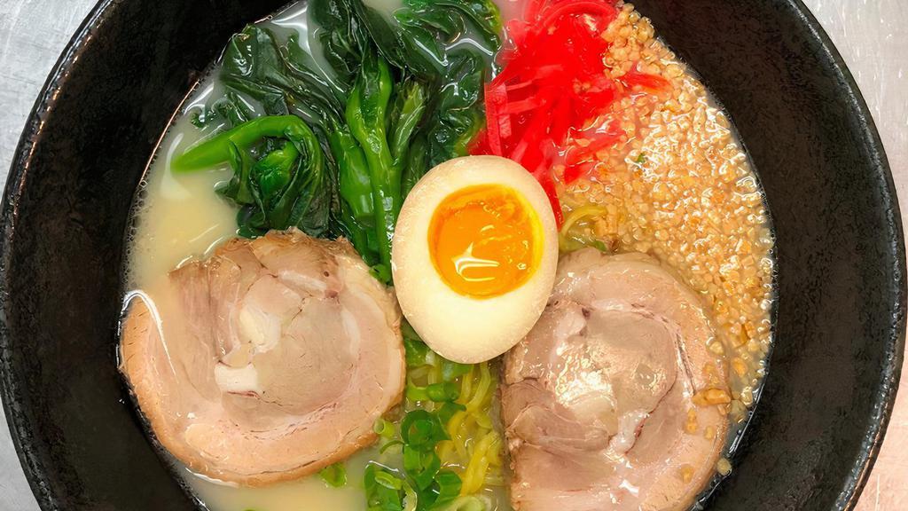Tonkotsu Ramen · Rich and creamy pork base in soup with char siu, choy sum, chopped garlic, green onion, soft egg.