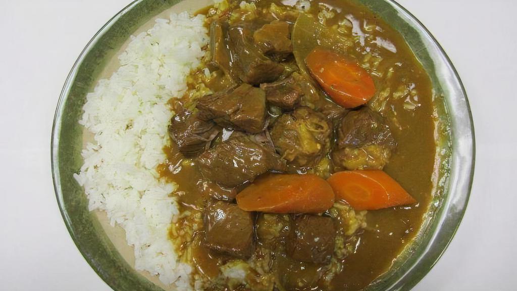 Beef Curry Rice · Tendered beef dices, golden curry sauce, carrot on white rice.