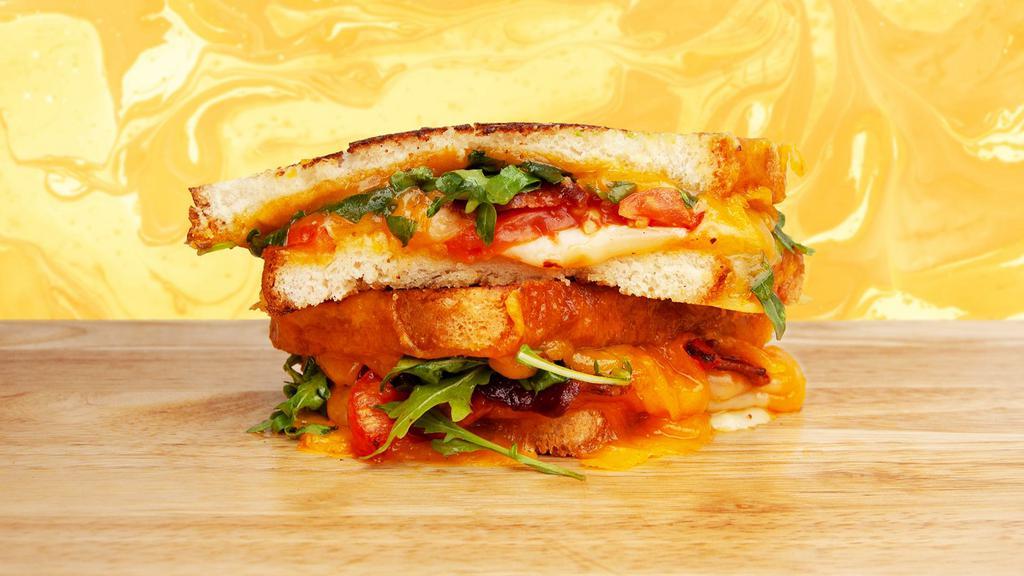 Blt Grilled Cheese · Melted cheddar, crisp bacon, lettuce, tomato, and mayo between two slices of buttery grilled bread.