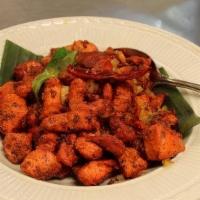 Chicken 65 · Spicy. Triple chili marinated cubes of white meat pan sauteed with curry leaves.