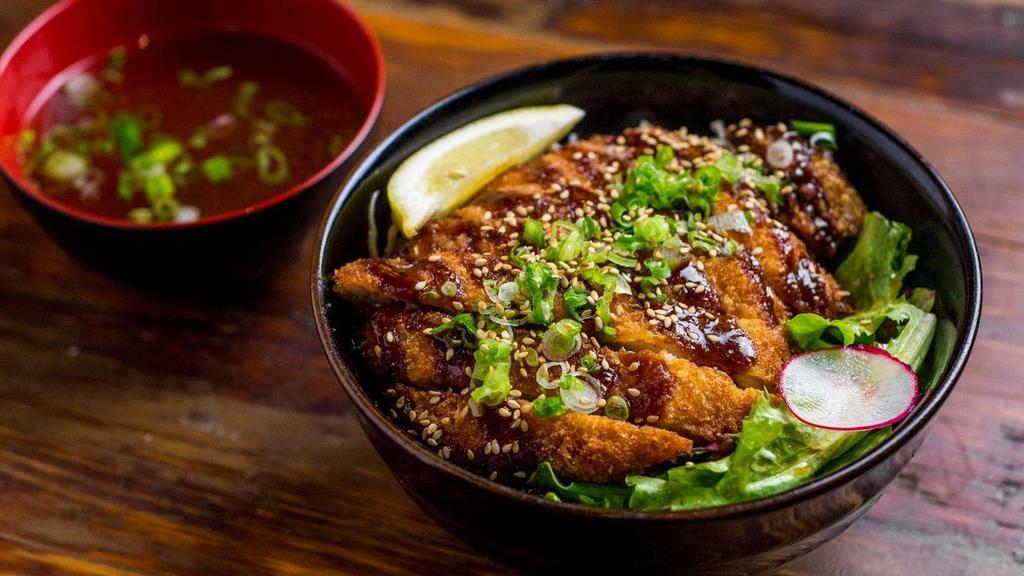 Japanese Pork Katsu Don · Worcestershire-based katsu sauce, greens, cabbage,  and sesame. A Japanese rice bowl served with  miso soup.