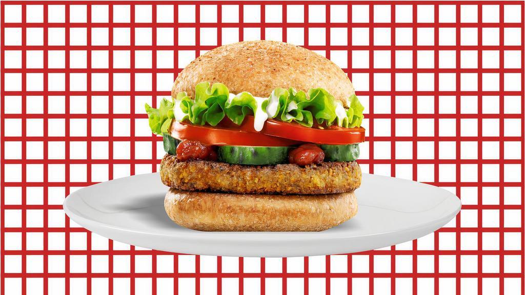 Falafel Burger · Crisp falafel patty, Mediterranean style with fresh greens, pickles, shaved onions, Roma tomatoes, and tahini sauce.