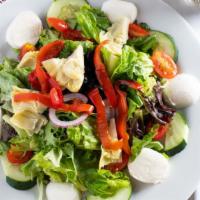 Summer Fiesta Salad · Mixed greens, tomatoes, onions, olives, cucumbers, fresh mozzarella, sun-dried tomatoes, roa...