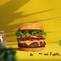 The New Classic Vegan Burger · Seasoned plant-based patty topped with lettuce, tomato, onion, and pickles. Served on a bun.