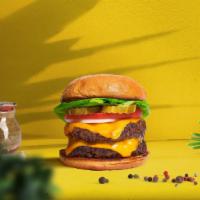 Cloned Cheese Burger · Two seasoned plant-based patties topped with melted vegan cheese, lettuce, tomato, onion, an...