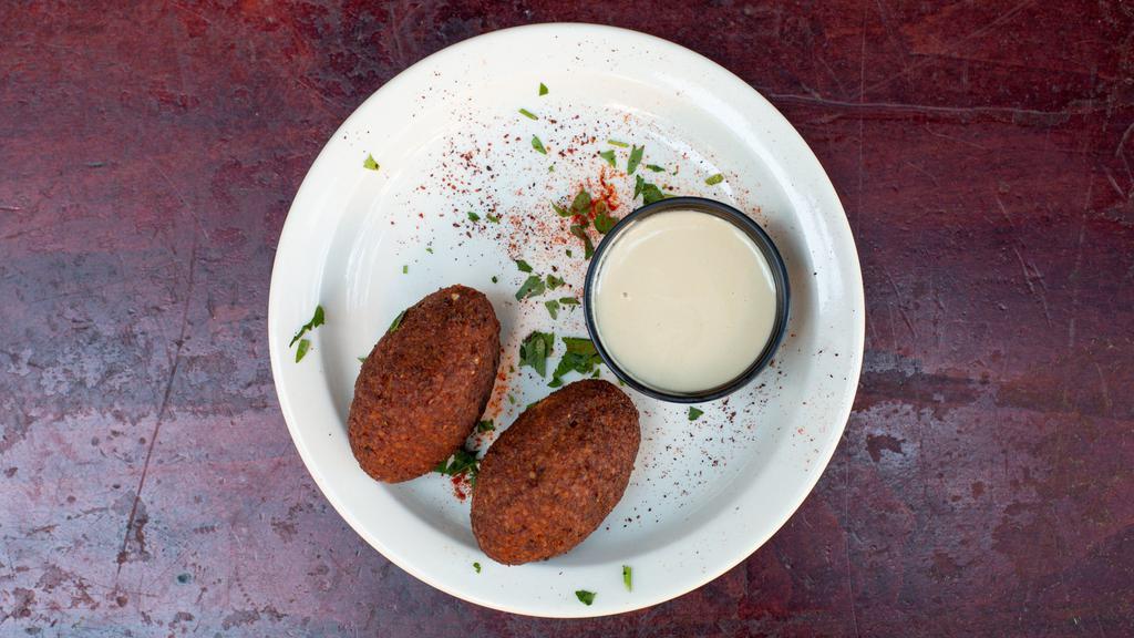 2-Piece Kibbeh Balls · Fried balls of burgoul with pine nuts, peppers and ground meat.