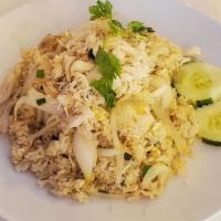 Crab Meat Fried Rice · Fried rice with white crab meat, egg and white and green onion. Topped with cilantro and cuc...