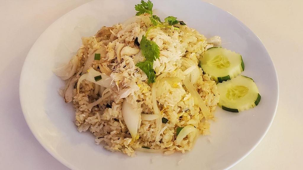 Crab Meat Fried Rice · Fried rice with white crab meat, egg and white and green onion. Topped with cilantro and cucumber.