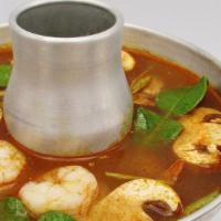 Tom Yum Shrimps  · Thai style hot and sour soup with shrimps , mushroom, tomato, kaffir lime leaves, galanga, l...